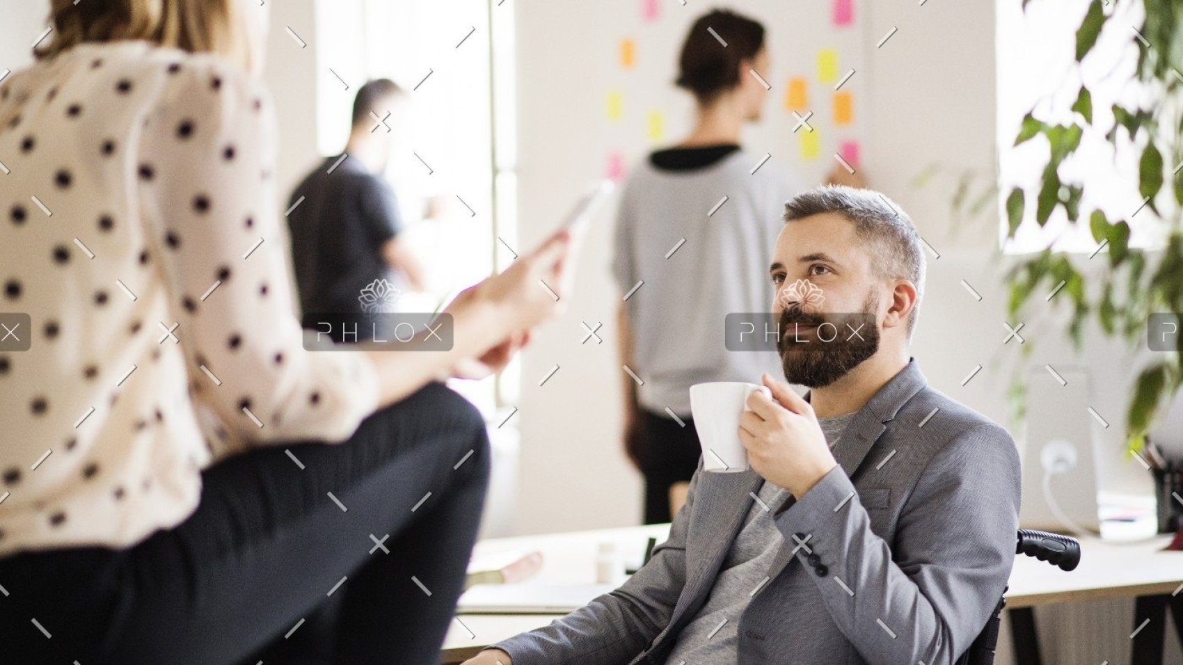 demo-attachment-438-business-people-with-wheelchair-in-the-office-P9M4RX3