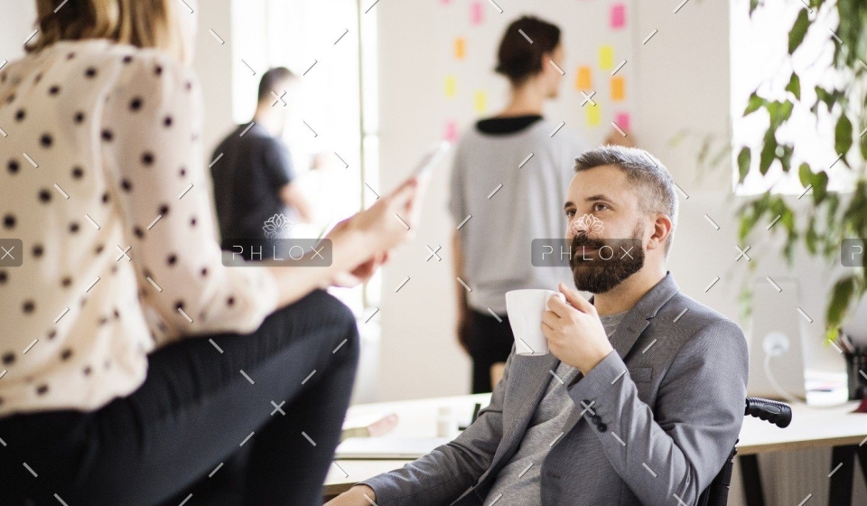 demo-attachment-438-business-people-with-wheelchair-in-the-office-P9M4RX3
