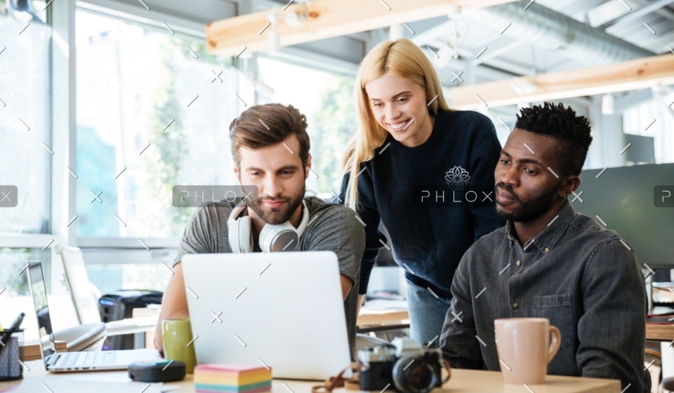 demo-attachment-447-happy-colleagues-sitting-in-office-coworking-PHYA6TG